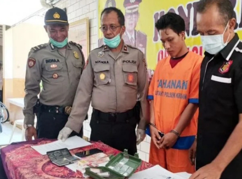 Tersangka MSH saat di Mapolsek Krian bersama barang bukti
