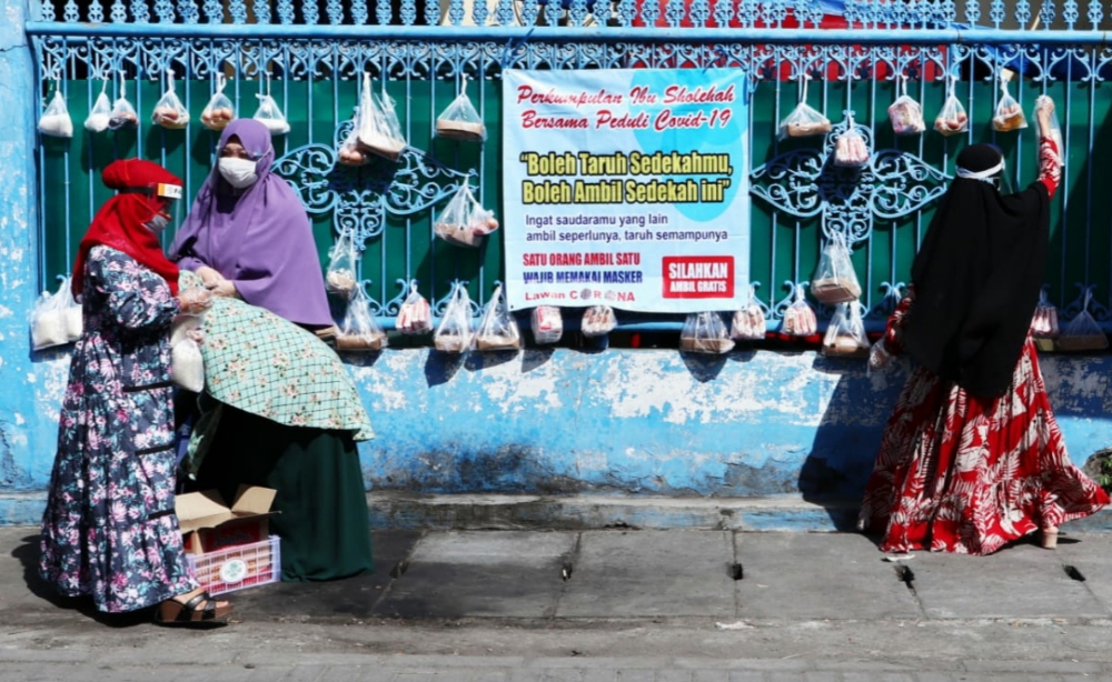 Anggota Komunitas Ibu Sholihah Surabaya saat mengantungkan Sembako Gantung