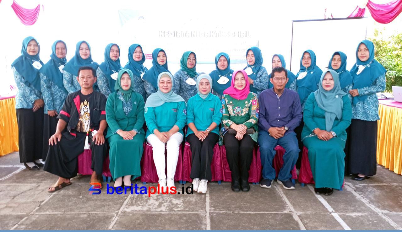 Penerima bantuan sosial paket sembako berfoto bersama ketua TP PKK Susilowati
